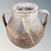 An antique twin handled pot,