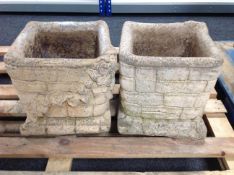 A pair of concrete brick and ivy planters