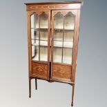 A late Victorian inlaid mahogany double door cabinet on raised legs