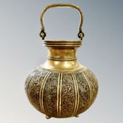 A 19th century Indian brass and copper swing-handled bulbous vessel, height 22cm including handle.