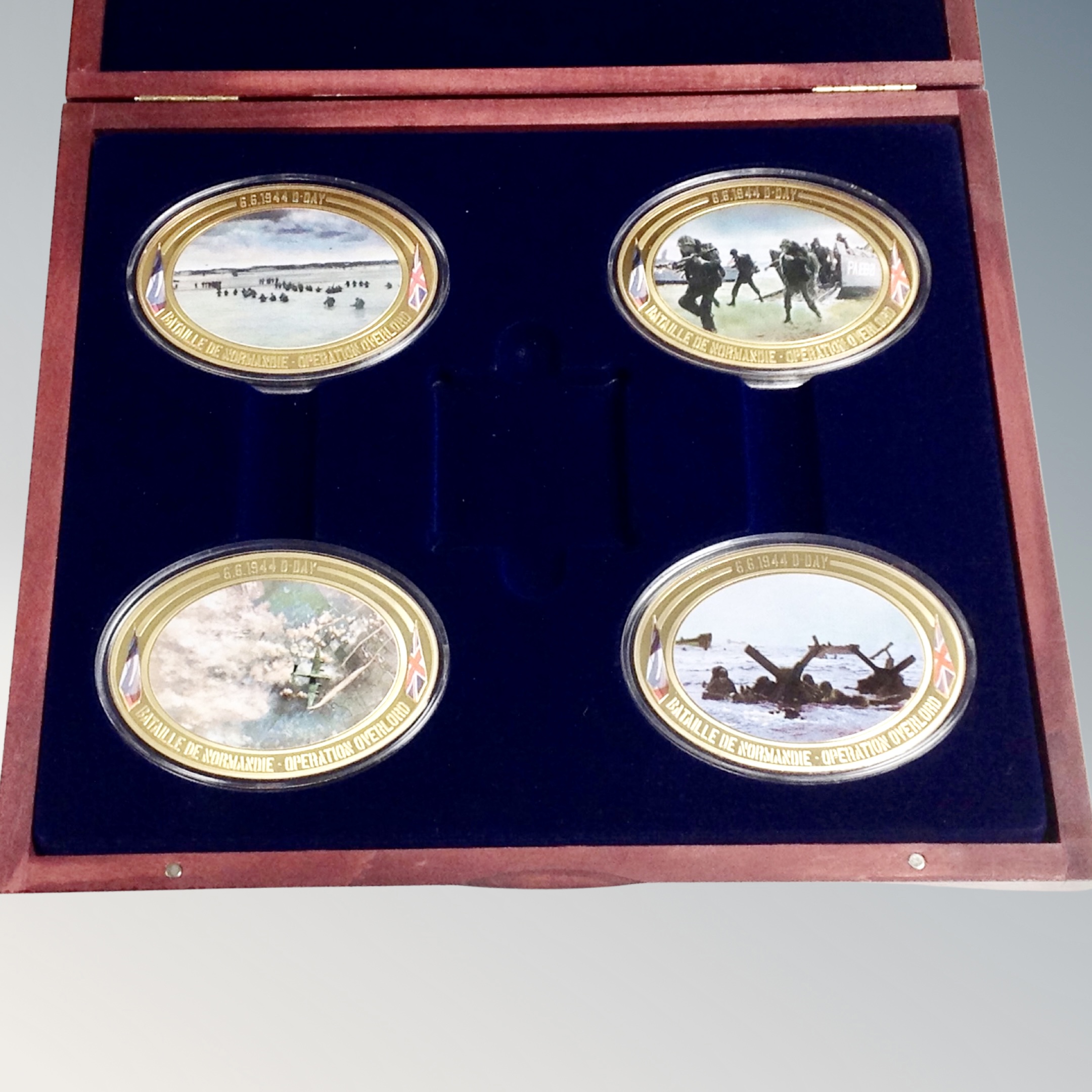 A set of four 24ct gold plated D-Day Landing coins in case