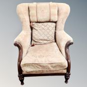 A Victorian style wingback armchair