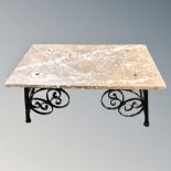 A marble topped low coffee table on iron base