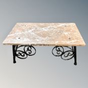 A marble topped low coffee table on iron base