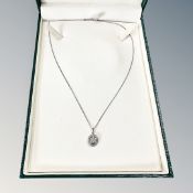 An 18ct white gold diamond set pendant on chain, 4g.