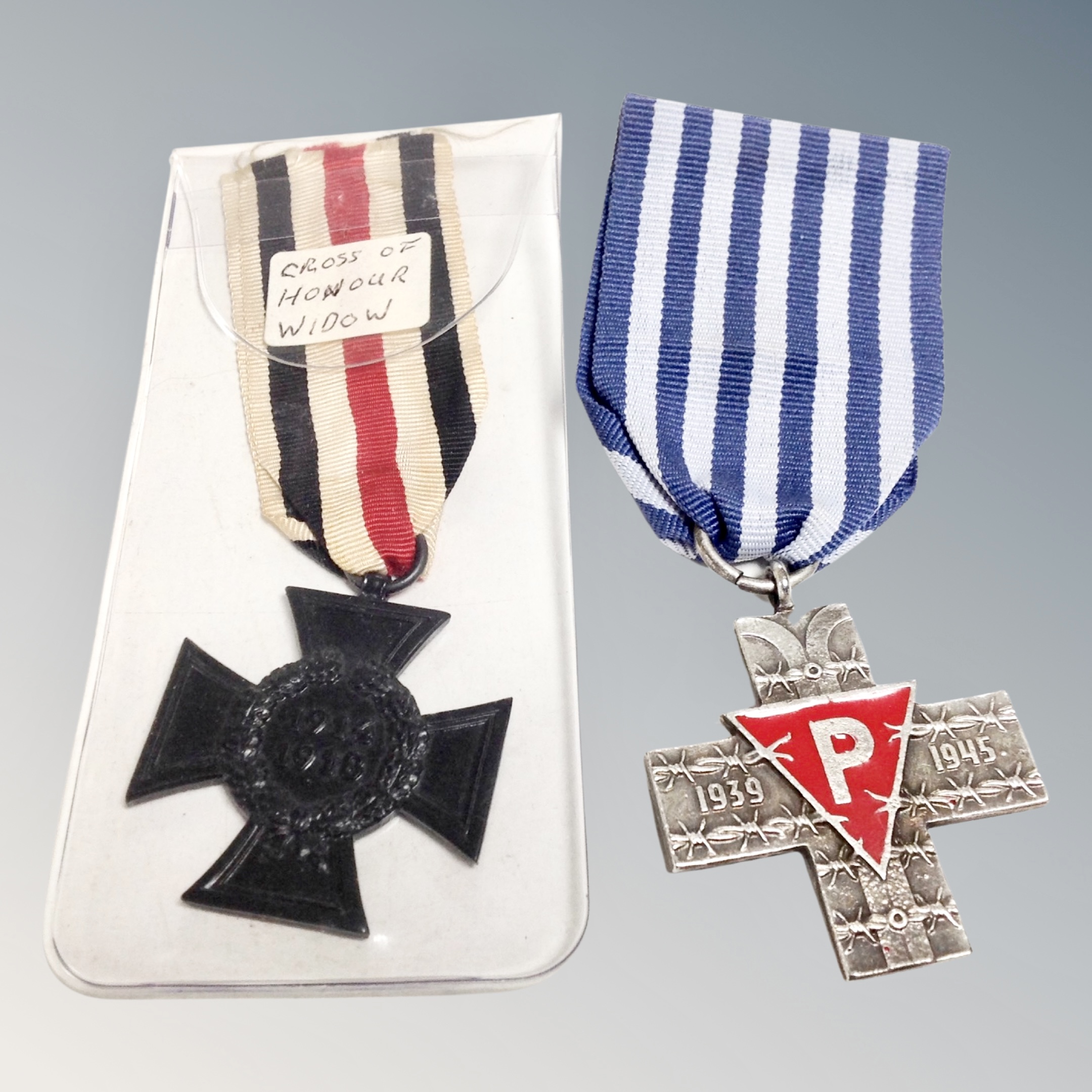 A WWI German cross of honour medal on ribbon together with a further WW II Polish cross