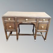 A 20th century oak gothic style five drawer kneehole desk
