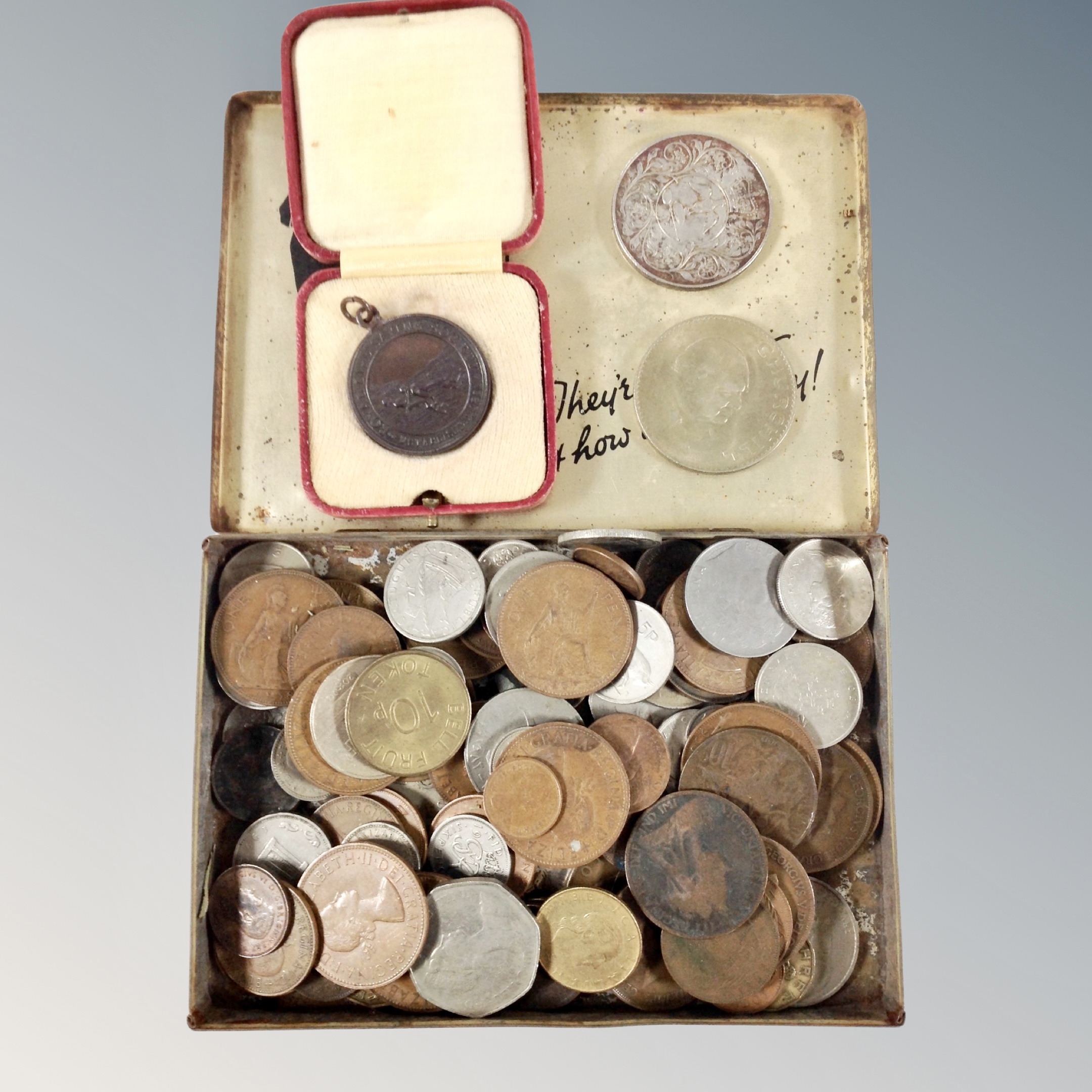A Royal life Saving medal in case together with a tin containing 19th and 20th century British and