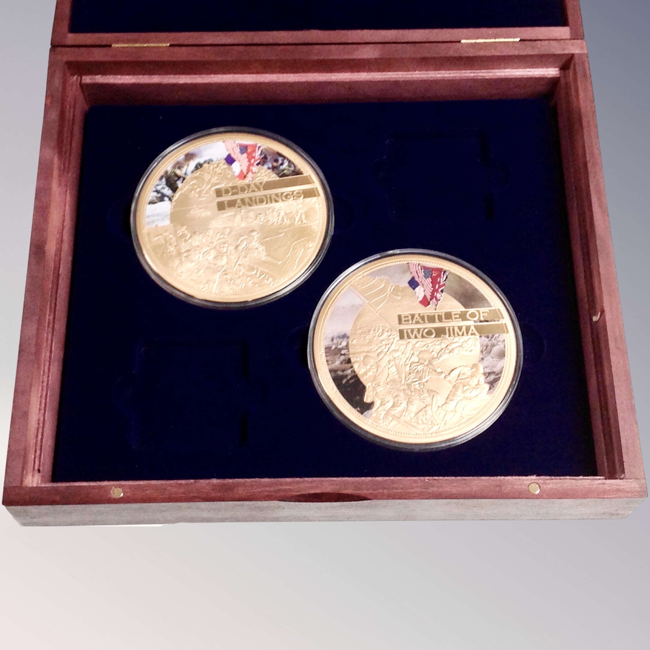 A pair of 24ct gold plated D-Day Landing and Battle of Iwo Jima commemorative coins in case