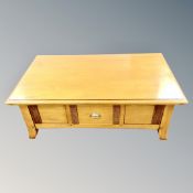 A contemporary storage coffee table with cantilever top