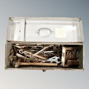 A metal engineer's tool box containing a quantity of assorted vintage spanners
