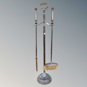 A Victorian brass two-piece companion set on stand