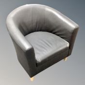 A faux leather tub armchair