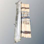 A bundle of staircase spindles together with a roll of radiator heat foil