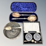 A silver plated wine coaster, pair of cut glass salts, cased pair of plated spoons,