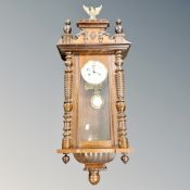 A 19th century Vienna wall clock surmounted by an eagle