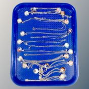 A tray of contemporary pendants on silver finished chains