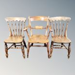 A pair of elm and beech spindle backed chairs together with armchair,