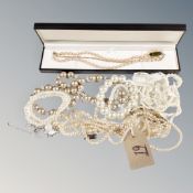 A boxed strap of pink cultured pearls with silver catch,
