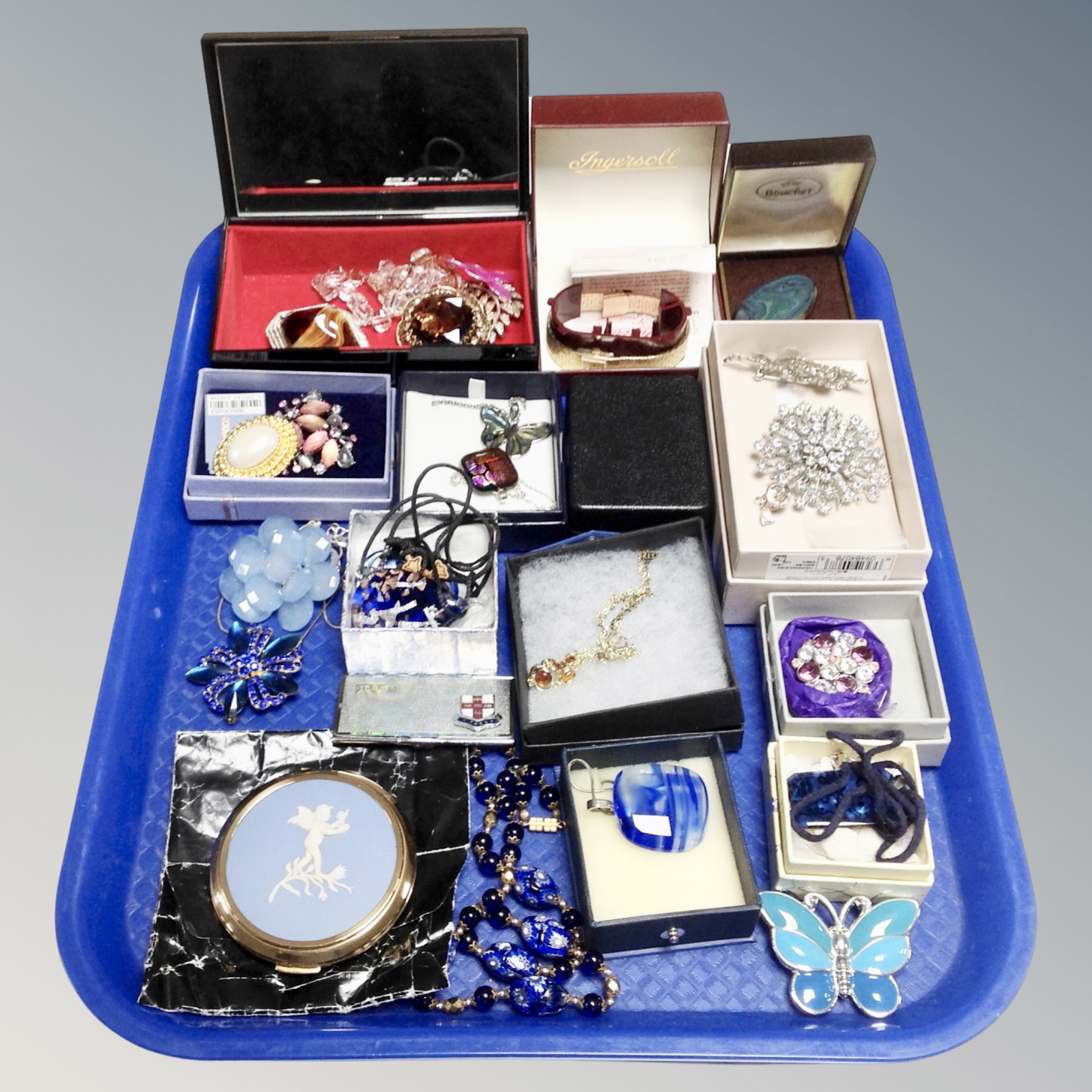 A tray of assorted costume jewellery, white metal brooches, glass pendants, Wedgwood compact,