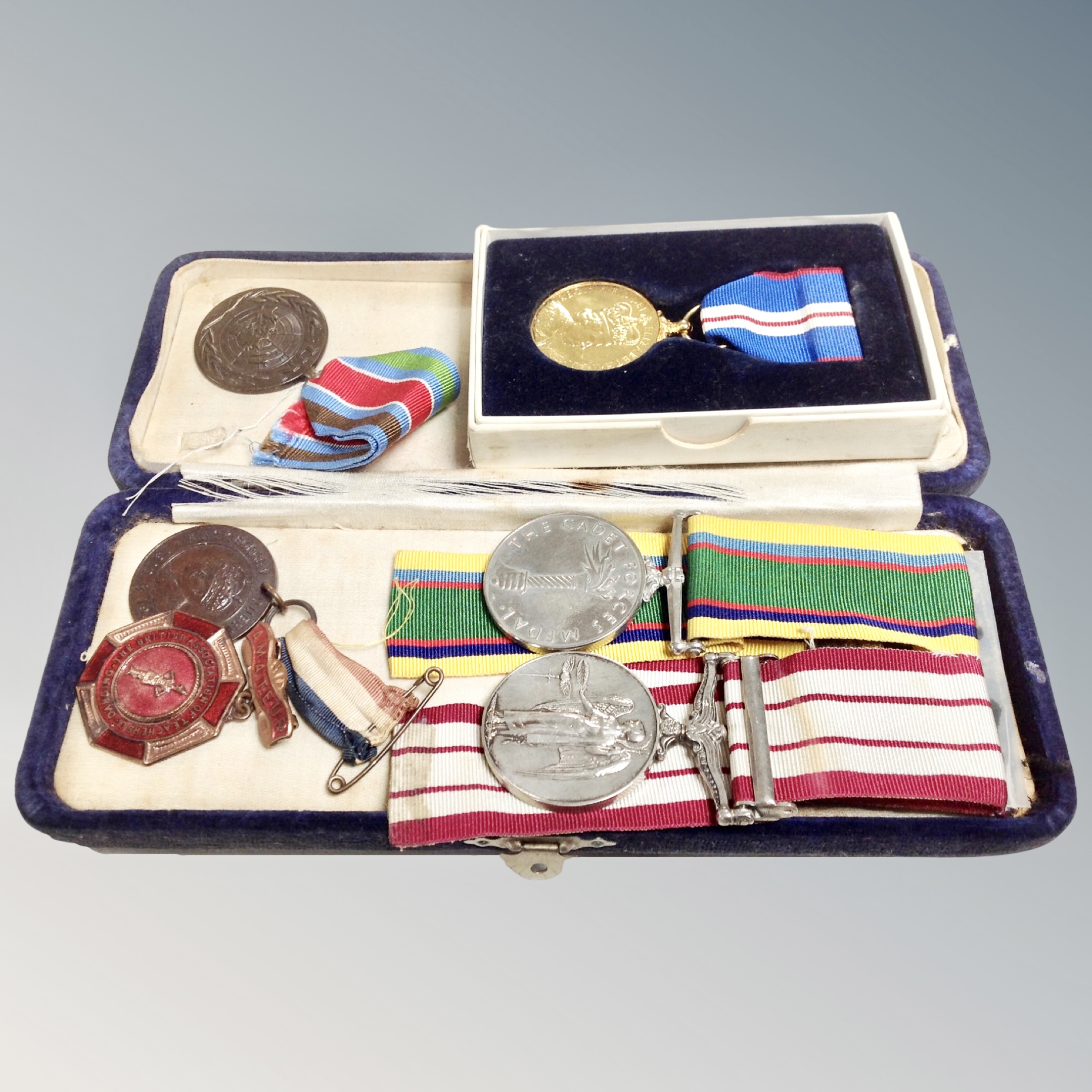 A group of five medals on ribbons, Naval service medal, Cadet medal, King George V Coronation,
