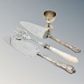 A Victorian silver egg cup and three items of silver mounted cutlery including toasting fork