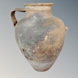 An antique pottery single handled urn (af),