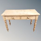 A Victorian pine kitchen side table fitted with two drawers, 77cm high by 101cm wide by 54cm deep.