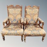 A pair of Victorian carved mahogany high backed armchairs upholstered in classical fabric