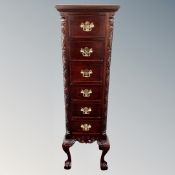 An Eastern narrow six drawer chest on claw and ball feet with brass dropped handles
