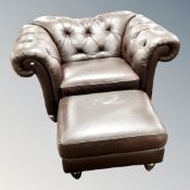 A Natuzzi brown buttoned leather oversized club armchair with footstool