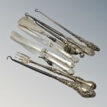 A group of silver mounted button hooks, silver handled knives,