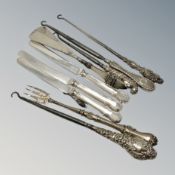 A group of silver mounted button hooks, silver handled knives,