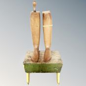 A pair of vintage wooden boot stretchers together with a cracket