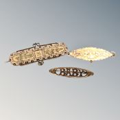 An antique gold 'baby' brooch together with two further similar brooches, 6.35g.