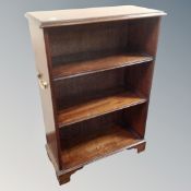 A Victorian style mahogany open bookcase with brass handles