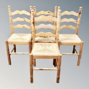 A set of four pine rush seated ladder backed chairs