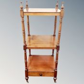 A Victorian mahogany three tier what-not stand fitted with a drawer