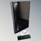 A Sony 40 inch LCD TV with remote and table stand