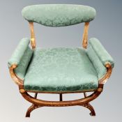 An inlaid mahogany Art Nouveau armchair in green fabric