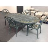 A wrought metal oval garden table together with six armchairs