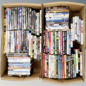 Two boxes containing approximately 100 dvds