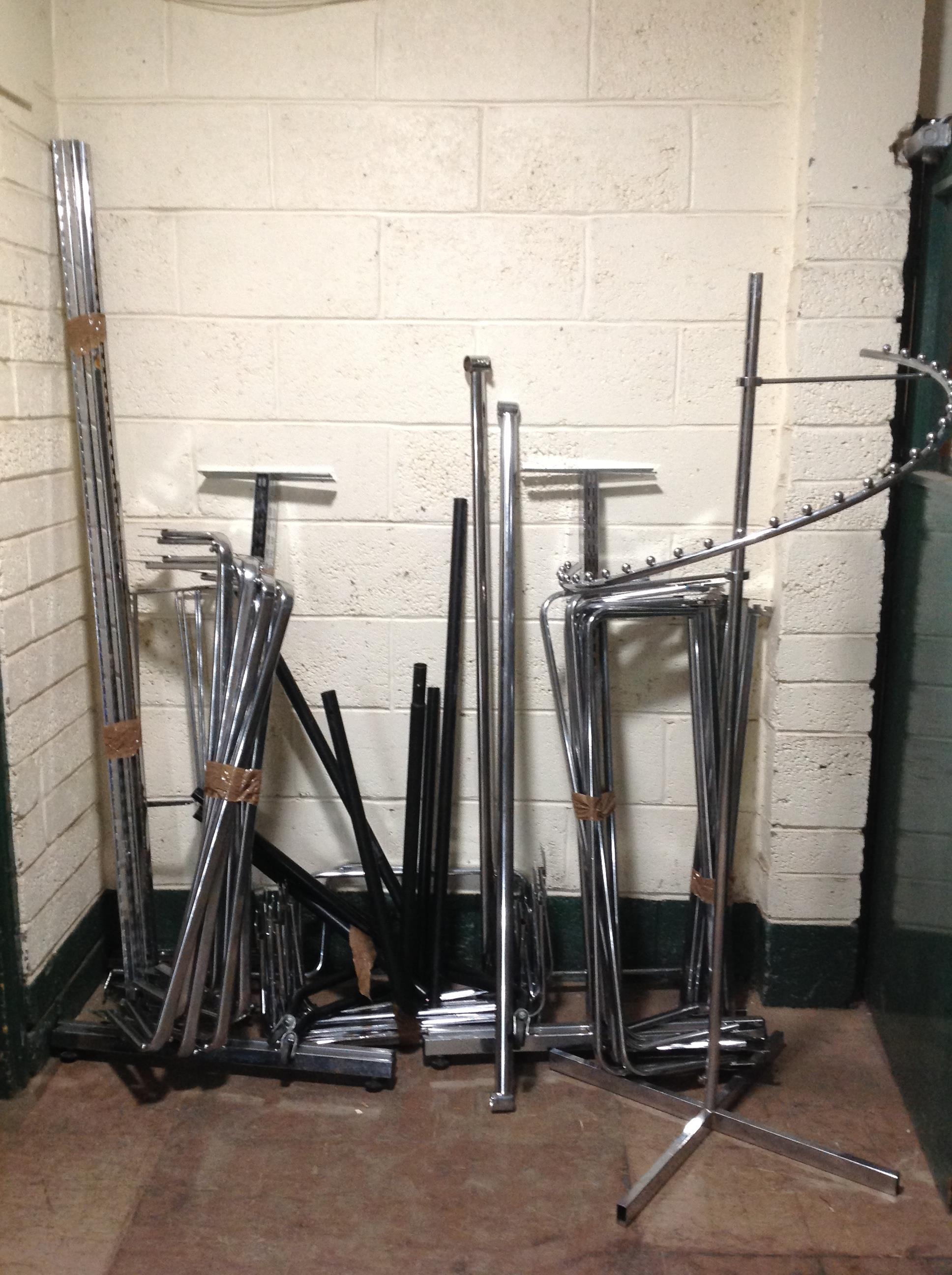 A quantity of metal shop clothes rails and fittings