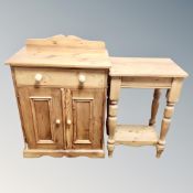 A pine double door cabinet fitted a drawer together with a pine two tier table