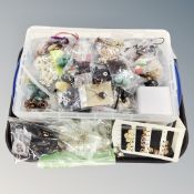A tray of costume jewellery, beads, earrings,