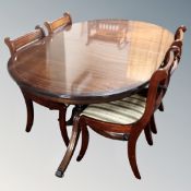 A Regency style oval twin pedestal dining table with four chairs