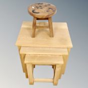 A nest of three contemporary oak tables together with milking stool depicting a cat with kitten