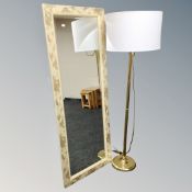 A contemporary gilt hall mirror and brass standard lamp with shade