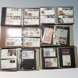 A box of six albums of First Day covers, bag of loose stamps,