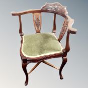 A carved Edwardian corner chair